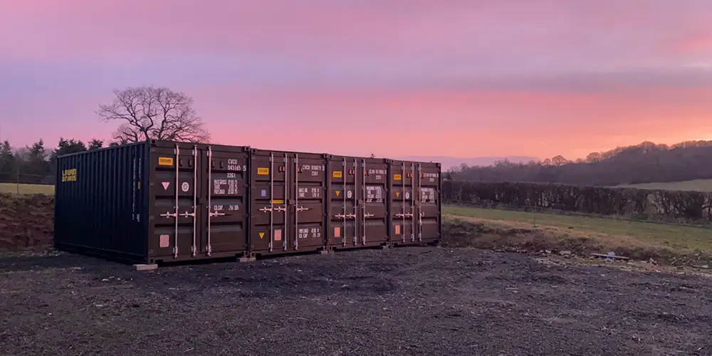 Open-air parking spaces for caravans and motorhomes beside the storage containers